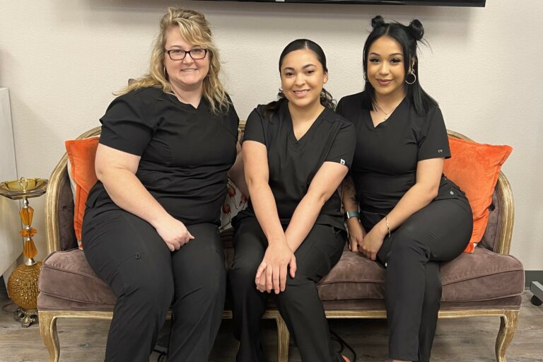 3 apprentices sitting together on a couch